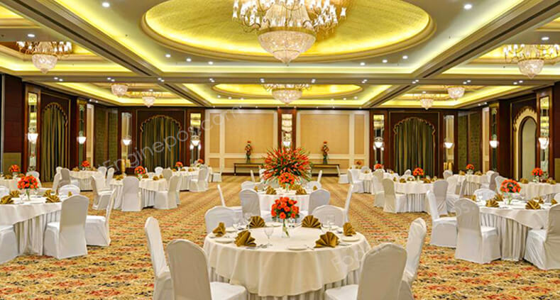 A group of decorated tables and chairs arranged neatly in a grand banquet hall
