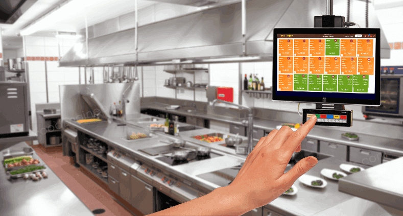A hand working on the Kitchen Display System mounted on a wall of a restaurant kitchen